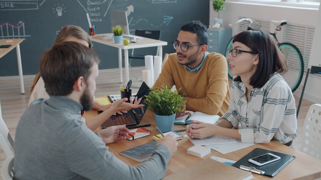 Startup team brainstorming around a whiteboard in modern office